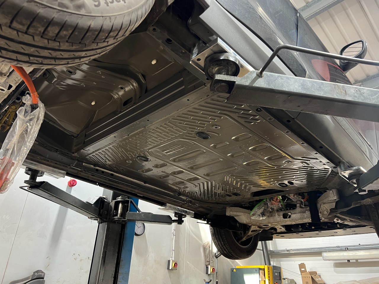 ford mache-e on ramp underneath car battery