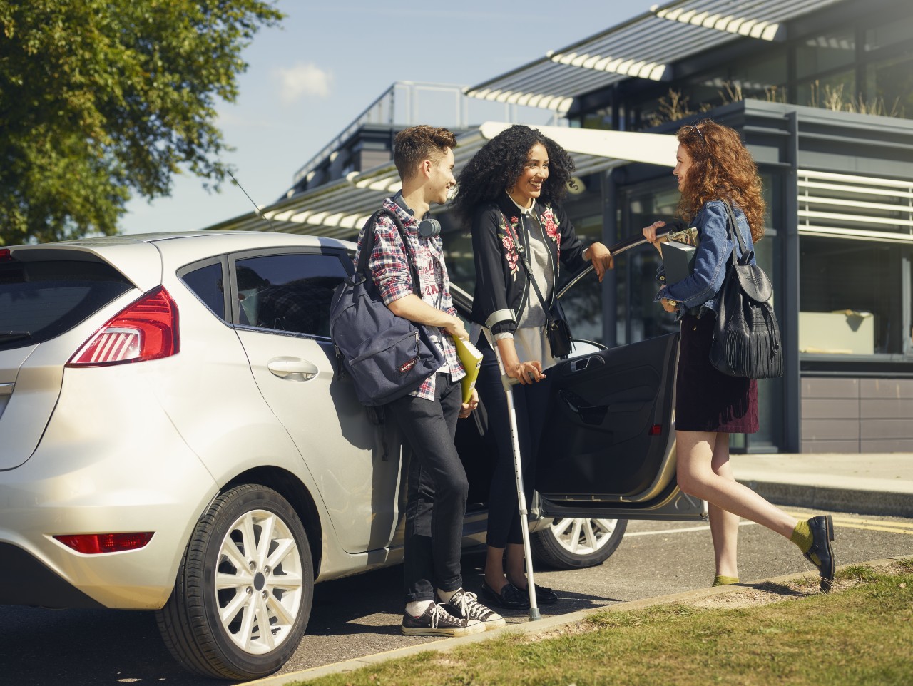 student on crutches driving car