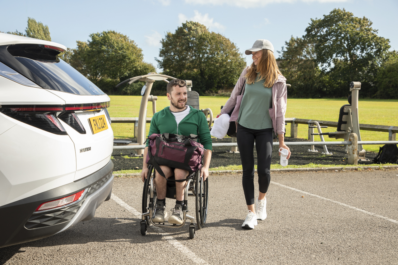 man in wheelchair with motability car